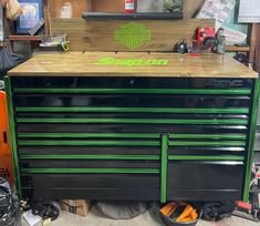 a green and black tool cabinet in a garage