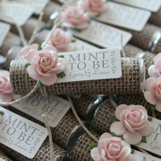 small pink roses are tied to twine and placed on top of each other with price tags