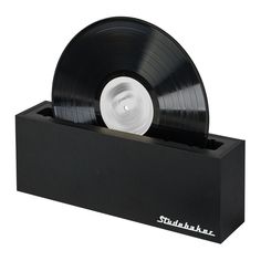 a black record player with white wheels on it