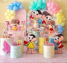 there are many balloons and decorations on the table for children's birthday party with cartoon characters