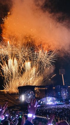 fireworks are lit up in the night sky at a concert