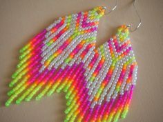 a pair of colorful beaded earrings on a table