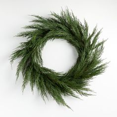 a close up of a green wreath on a white background with no people around it