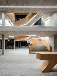 an empty building with some stairs in the center and lights at the top on either side