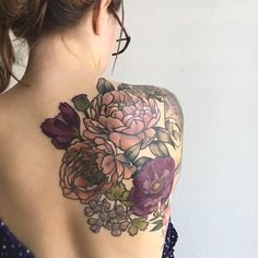 a woman with a flower tattoo on her back