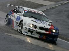 a white car driving down a race track