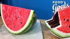 two slices of watermelon sitting on top of a cutting board next to each other