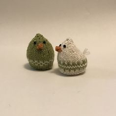 two knitted birds sitting next to each other