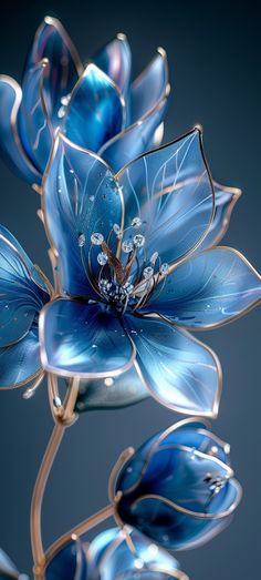 a blue flower that is sitting in the middle of some glass flowers with water droplets on it