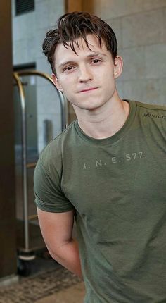 a young man standing in front of an elevator