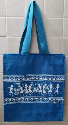 a blue bag hanging on the wall in front of a white tile wall and tiled floor