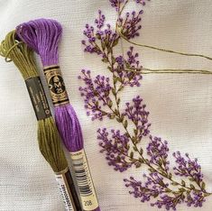 two skeins of yarn next to some lavender flowers