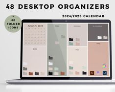 an open laptop computer sitting on top of a white table next to a wall calendar