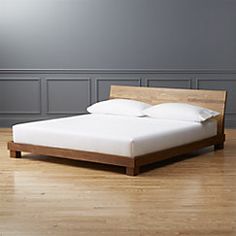 a bed sitting on top of a hard wood floor