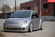 a silver car parked in front of a brick building