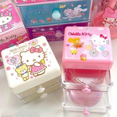 several hello kitty boxes are lined up on the table