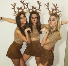 three women dressed up as deer antlers posing for the camera
