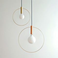 two white and gold lights hanging from the ceiling