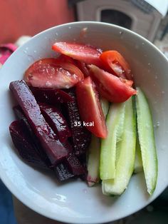 a white bowl filled with sliced up vegetables