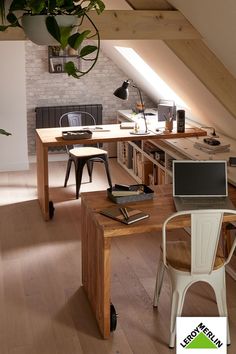 a desk with a laptop computer on top of it next to a chair and potted plant
