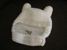 a crocheted white hat with ears on it