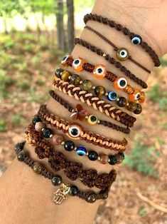 a hand holding several bracelets with evil eyes on them