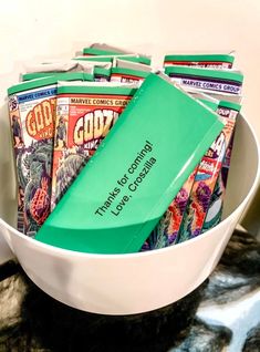 a bowl filled with magazines on top of a table