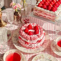 a table topped with plates and cakes covered in frosting