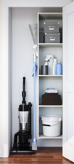 a white shelf filled with lots of cleaning supplies next to a bucket and mop