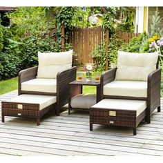 an outdoor patio with wicker furniture and white cushions