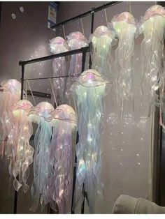 several jellyfish lights hanging from a metal rack
