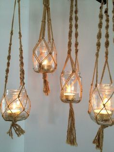 three hanging mason jars filled with candles