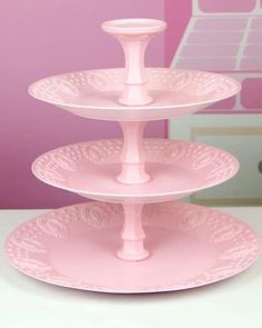 three tiered cake stand with pink frosting