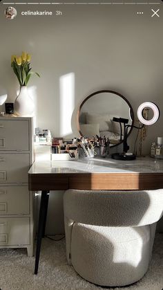 a desk with a mirror and some drawers