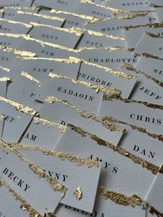 many business cards with gold foil on them