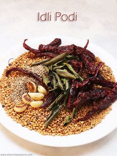 there is a white plate filled with beans and vegetables on top of each other, along with the words ladi podi above it