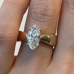 a woman's engagement ring with a pear shaped diamond