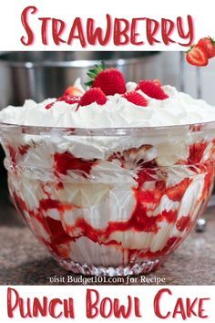 strawberry trifle in a glass bowl with whipped cream and strawberries on the top