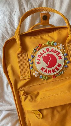 Fjallraven Kanken Backpack Yellow, Kanken Backpack Yellow, Yellow Kanken Backpack, Embroidery On A Backpack, Yellow Kanken Aesthetic, Fjallraven Kanken Embroidered Diy, Embroided Backpacks, Kanken Embroidery Ideas