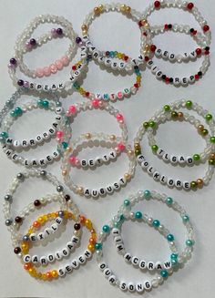 six bracelets with words and beads on them