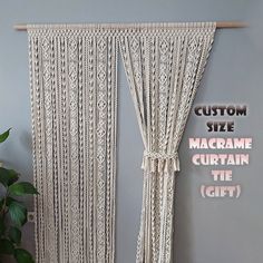 a macrame curtain hanging on the wall next to a potted plant