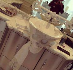 a white sink sitting on top of a bathroom counter next to a mirror and drawers