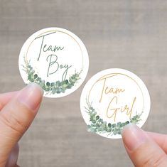 two stickers with the words team boy and team girl written on them in gold foil