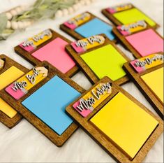 colorful sticky notes are arranged on a white furnishing surface with greenery in the background