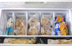 an open refrigerator filled with lots of food and plastic containers on top of each other