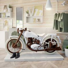 a white motorcycle is on display in a room with wooden walls and flooring,