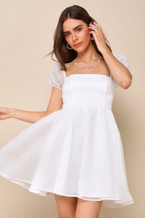 This season will be full of style and compliments with a spring-approved look like the Lulus Sweetest Grace Shiny White Organza Puff Sleeve Mini Dress! Crinkle-woven organza, with a luminous sheen throughout, shapes this darling dress that features a princess-seamed bodice, a trendy square neckline, and sheer puff sleeves (with elastic at the shoulders and cuffs). The high, fitted tops a twirly, skater-style skirt that ends at a flirty mini hem. Long tying sashes secure at the back, atop a smock Grad Party Dresses, Mini Graduation Dress, Graduation White Dress, White Graduation Dresses, White Dress Classy, Dress Crinkle, Cheer Dress, Wedding Event Dresses, White Babydoll Dress