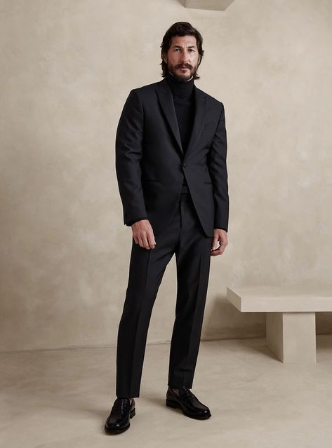 Chic, all-black ensemble featuring a tailored suit, cozy turtleneck, and leather penny loafers. A perfect blend of elegance and contemporary style, suitable for any sophisticated occasion. Men Suit Without Tie, Turtleneck Suit Outfit Men, Black Wedding Attire Guest Men, Black Tie Menswear, Groom Wedding Suit Black, Men All Black Suit, Turtleneck Suit Men, All Black Outfit Men Formal, All Black Mens Outfit Formal