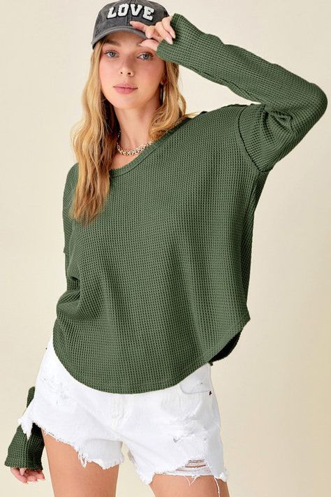 Thick waffle-knit top with raw edge and stitch detail. Every day casual wear- a loose regular fit. 65% POLYESTER/35%COTTON Hand wash only cold, no dryer Waffle Toppings, Waffle Fabric, Cozy Tops, Waffle Knit Top, Long Sleeve Knit Tops, Basic Tops, Sheer Fabrics, Waffle Knit, Knitting Designs