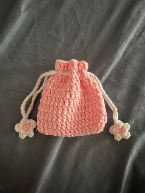 Handmade crochet mini cinch pouch🌸 If you have any questions, or suggestions about the product please reach out to me. I'll be happy to respond Tissue Pouch Crochet, Crochet Makeup Brush Holder, Cute Pouch Aesthetic, Easy Mini Crochet Projects, Crochet Pouch Ideas, Crochet Inspo Ideas Aesthetic, Crochet Mini Projects, Coin Bag Crochet, Crochet Coin Bag